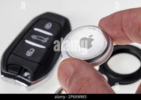 Man hand holding Apple AirTag, icon image, tracking tag, key finder ...
