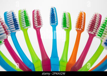 Many different colored toothbrushes in toothbrush cup, detail, symbol image, teeth cleaning, white background, Stock Photo