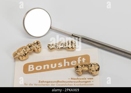 Bonus booklet, three used partially veneered dental bridges, mouth mirror, detail, symbol image, denture, co-payment, white background, Stock Photo