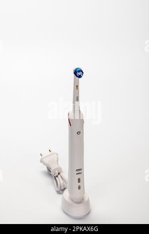 Braun Oral-B Type 3766 electric toothbrush on charging station, white background, Stock Photo