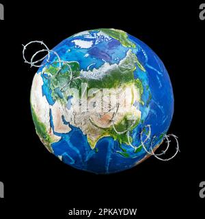 World War concept, toy globe wrapped in barbed wire across Russia and China. Stock Photo