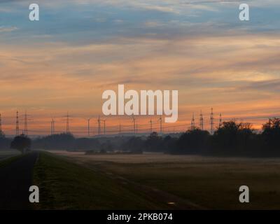 The Maine plain between Grafenrheinfeld and Bergrheinfeld at the Grafenrheinfeld nuclear power plant in fog and evening light, Schweinfurt county, Lower Franconia, Franconia Bavaria, Germany Stock Photo
