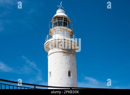 Paphos, Paphos District, Cyprus - March 23 , 2023 - View over the historical lighthouse at the coast against blue sky Stock Photo