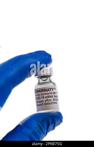 Close up on 2 fingers of the hand holding the vial. Stock Photo