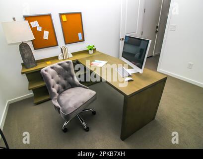Home Office With L-Shaped Desk And Chair Stock Photo