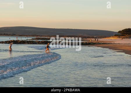 England, Dorset, Poole, Sandbanks Beach, Two Female Swimmers in The Sea Stock Photo