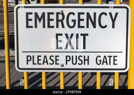 Emergency exit sign. Exterior, exit sign on a gate on a street. Nobody, selective focus Stock Photo