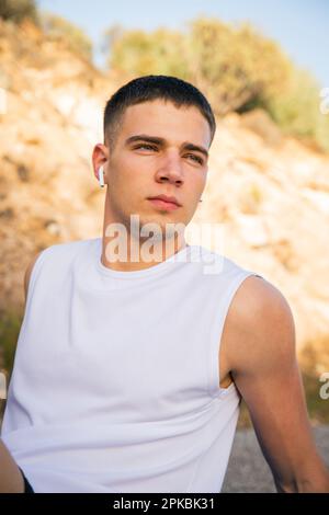 Portrait of a boy listening to music and exercising, concentrated sportsman. Stock Photo