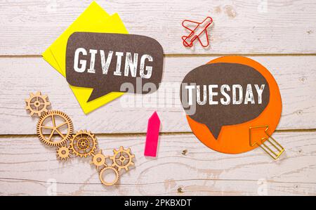 Giving Tuesday concept - handwriting on a napkin with a cup of espresso coffee. Stock Photo