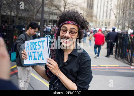 Anti-supporter of Donald J Trump holds sign outside Manhattan Criminal Court House, NYC, during Trump arraignment on 04 April 2023. Stock Photo