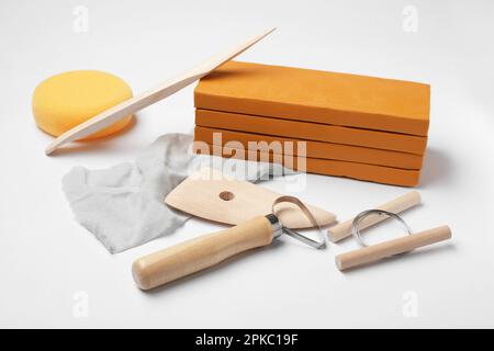 Clay and different modeling tools on white background Stock Photo