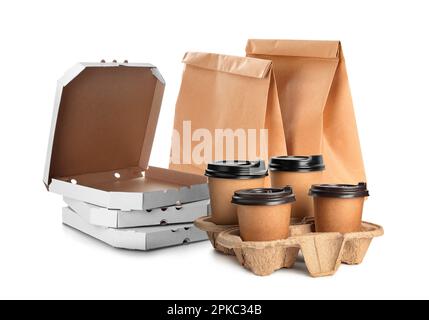 Set with cardboard pizza boxes, takeaway cups and paper bags on white background Stock Photo