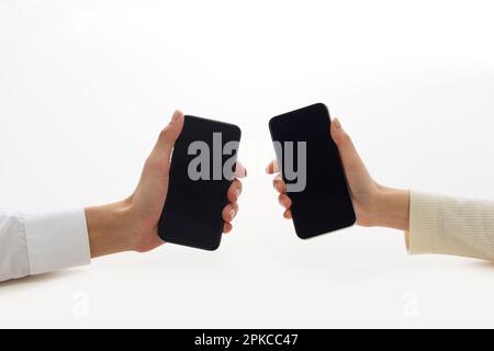Two hands holding a new smartphone Stock Photo