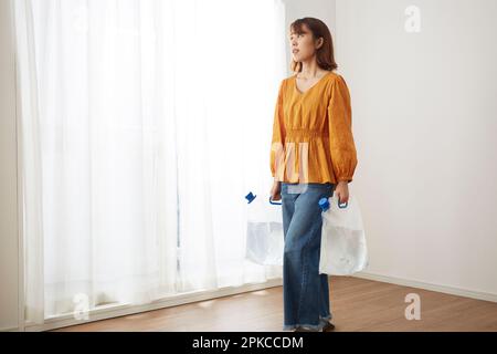 Woman with water in a water tank Stock Photo