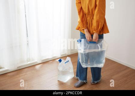 Woman with water in a water tank Stock Photo