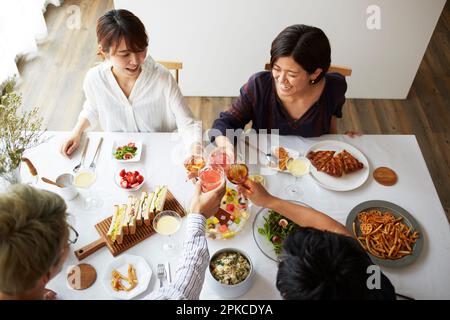 Group of men and women having a home party Stock Photo