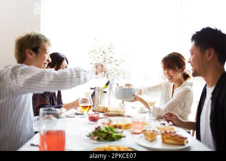 Group of men and women having a home party Stock Photo