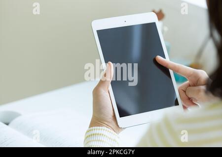 Female student studying using a tablet PC Stock Photo