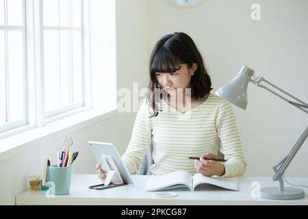 High school girl studying using a tablet PC Stock Photo