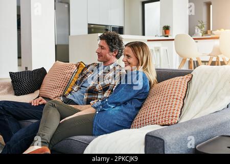 Our weekend to spend together. a mature married couple relaxing on the sofa at home. Stock Photo