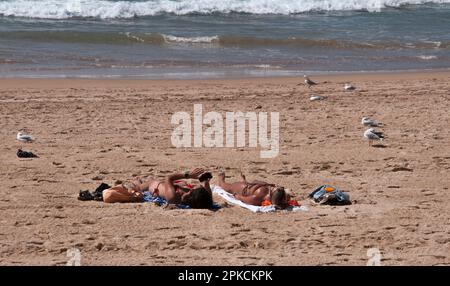 Women sunbathing on the beach at Manly, Sydney, New South Wales, Australia Stock Photo