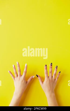 Woman's hand with par on yellow background Stock Photo