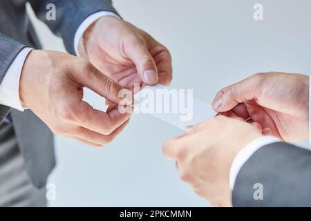 Two businessmen exchanging business cards Stock Photo