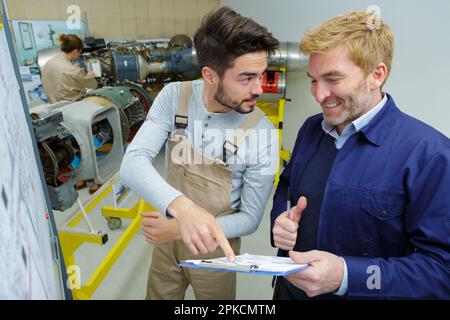 engineers discussing something in control room Stock Photo