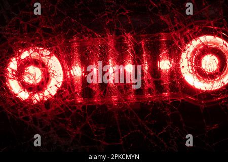 light from a red lantern shines through broken glass macro photo as a background Stock Photo