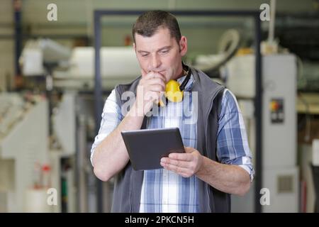 engineer uses laptop computers for machine maintenance Stock Photo