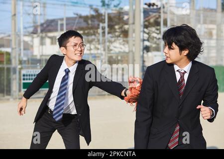 Two men in suits touching out Stock Photo