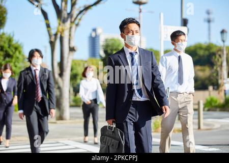 Office workers wearing masks to work Stock Photo