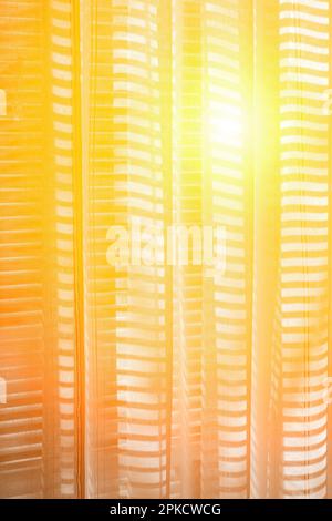 Bright sunlight through the curtain on the window. Stock Photo