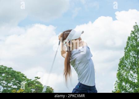 Women in their 20s playing golf Stock Photo