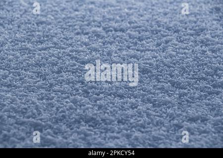 The surface of fresh fluffy bluish snow close-up. Stock Photo