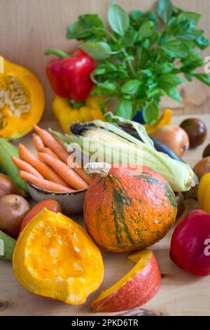 Fresh sliced pumpkin and assorted vegetables. Autumn photo. Healthy eating. Sliced pumpkin, zucchini, squash, bell peppers, carrots, onions, cut Stock Photo