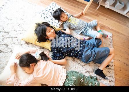 Children taking a nap in the living room Stock Photo