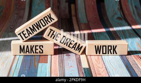 Concept words TMDW Teamwork make a dream job on a wooden block on a beautiful vintage background. Teamwork Business TMWD creates a dream job concept. Stock Photo