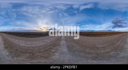 evening 360 hdri panorama on gravel road with clouds on blue sky before sunset in equirectangular spherical seamless projection, use as sky replacemen Stock Photo