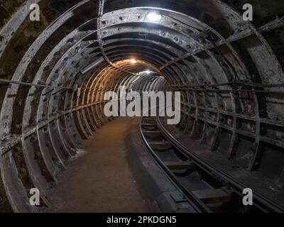 General view inside a tunnel of Mail Rail, the former Post Office Railway system under the streets of central London, England. Stock Photo