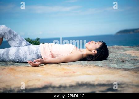 Japanese woman lying on a beach in swimsuit Stock Photo - Alamy
