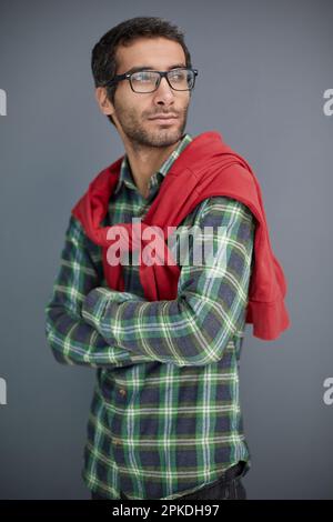 Portrait of gentlemen, manly, calm, intelligent man with serious expression, looking at camera over gray background Stock Photo