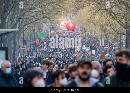Crowd of French people marching in a street of Paris, France during a demonstration against the governement's retirement reform Stock Photo