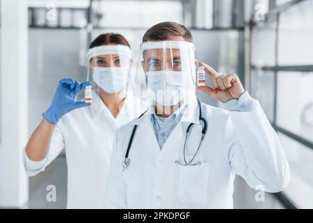 Two doctors in white coats is in the clinic working together. Stock Photo
