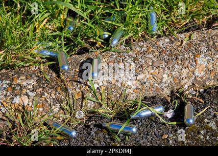 London, UK. 7th Apr, 2023. Canisters of Nitrous Oxide in a street in West London. The sale of Laughing Gas, or Nos as it is known, has been banned by the Government under the Misuse of Drugs Act 1971. They are trying to clamp down on antisocial behaviour. Credit: Karl Black/Alamy Live News Stock Photo