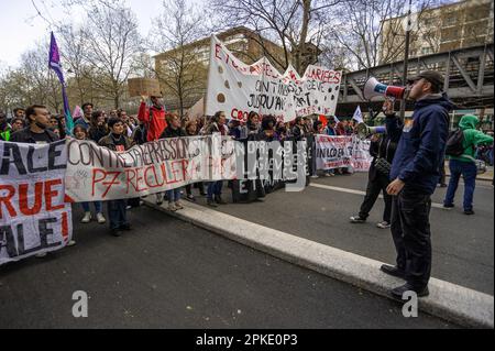 Protesters with banners and flags walk along the Boulevard Raspail during the demonstration. Unions in France, last week called for an 11th day of action for today. They consider ‘the lack of response from the government leads to a situation of tension of great concern” Unions said in a statement, they were calling “for local union rallies and a new big day of strikes and demonstrations throughout the country.” Protesters over the past two-weeks have clashed with police over the French government pension reform policy. President Emmanuel Macron decided to push through the controversial reforms Stock Photo