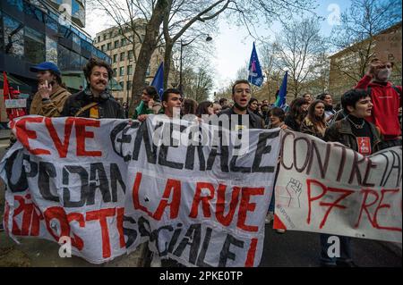 Protesters with banners and flags walk along the Boulevard Raspail during the demonstration. Unions in France, last week called for an 11th day of action for today. They consider ‘the lack of response from the government leads to a situation of tension of great concern” Unions said in a statement, they were calling “for local union rallies and a new big day of strikes and demonstrations throughout the country.” Protesters over the past two-weeks have clashed with police over the French government pension reform policy. President Emmanuel Macron decided to push through the controversial reforms Stock Photo