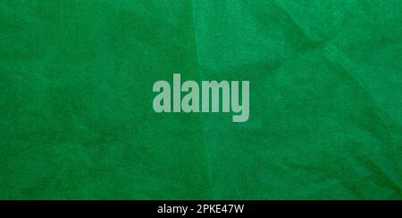 Crumpled dark green tracing paper as texture, holiday backdrop or background, long picture Stock Photo