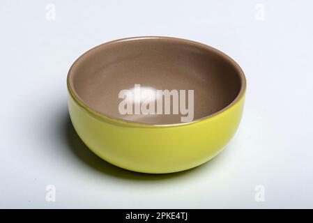 Modern green empty ceramic bowl with brown interior, isolated on white Stock Photo
