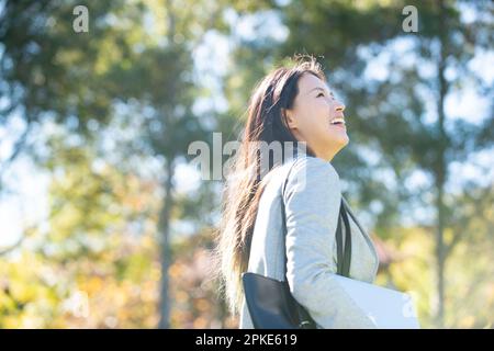 Woman looking up and smiling Stock Photo